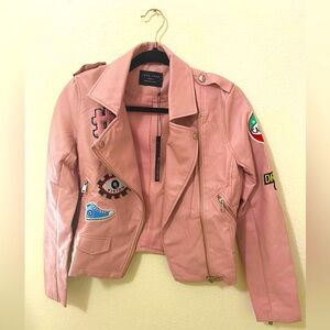 Faux leather pink jacket with multiple colorful cool stickers.